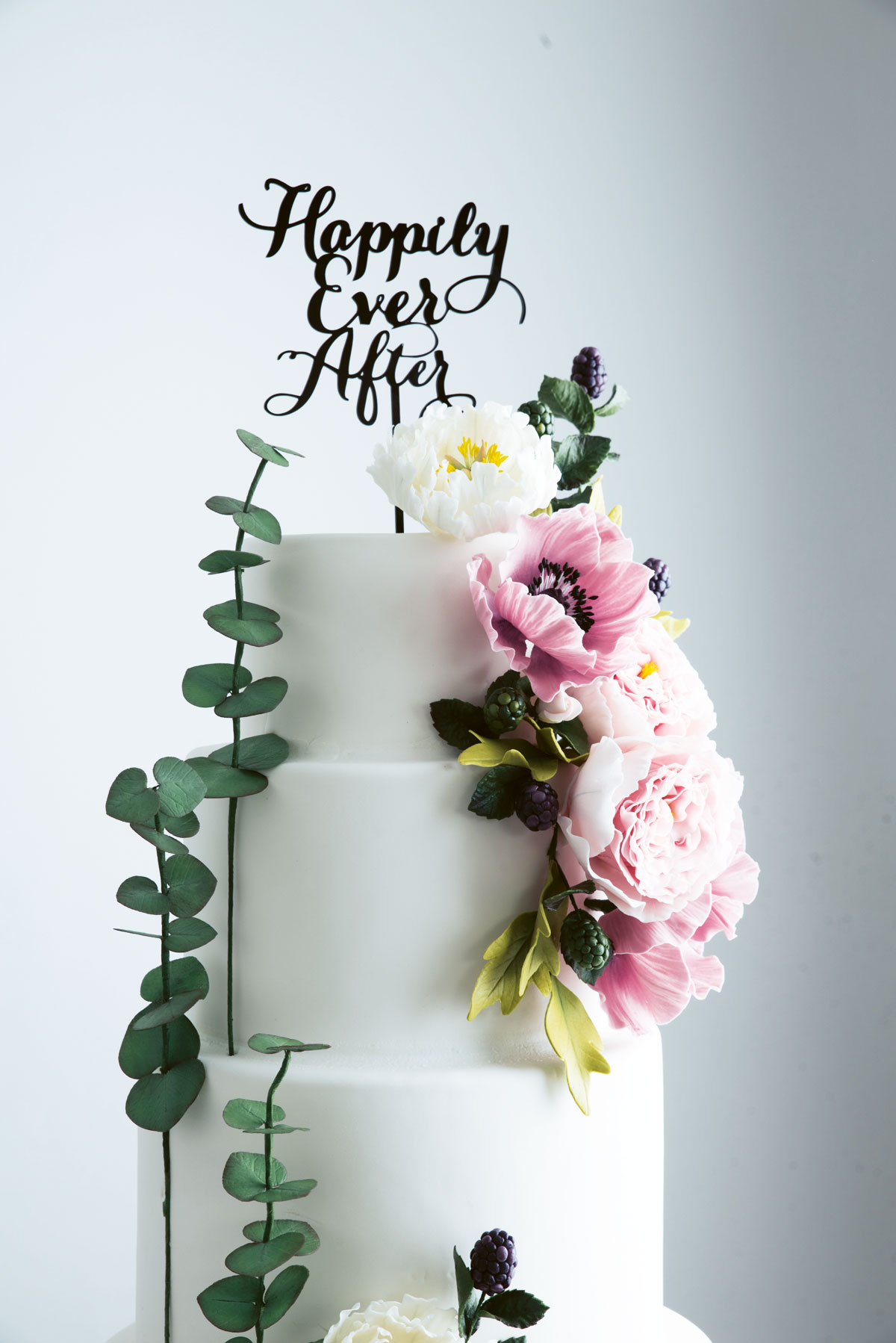 A beautiful three-tiered wedding cake by Cay Cuasay of Cupcake Lab