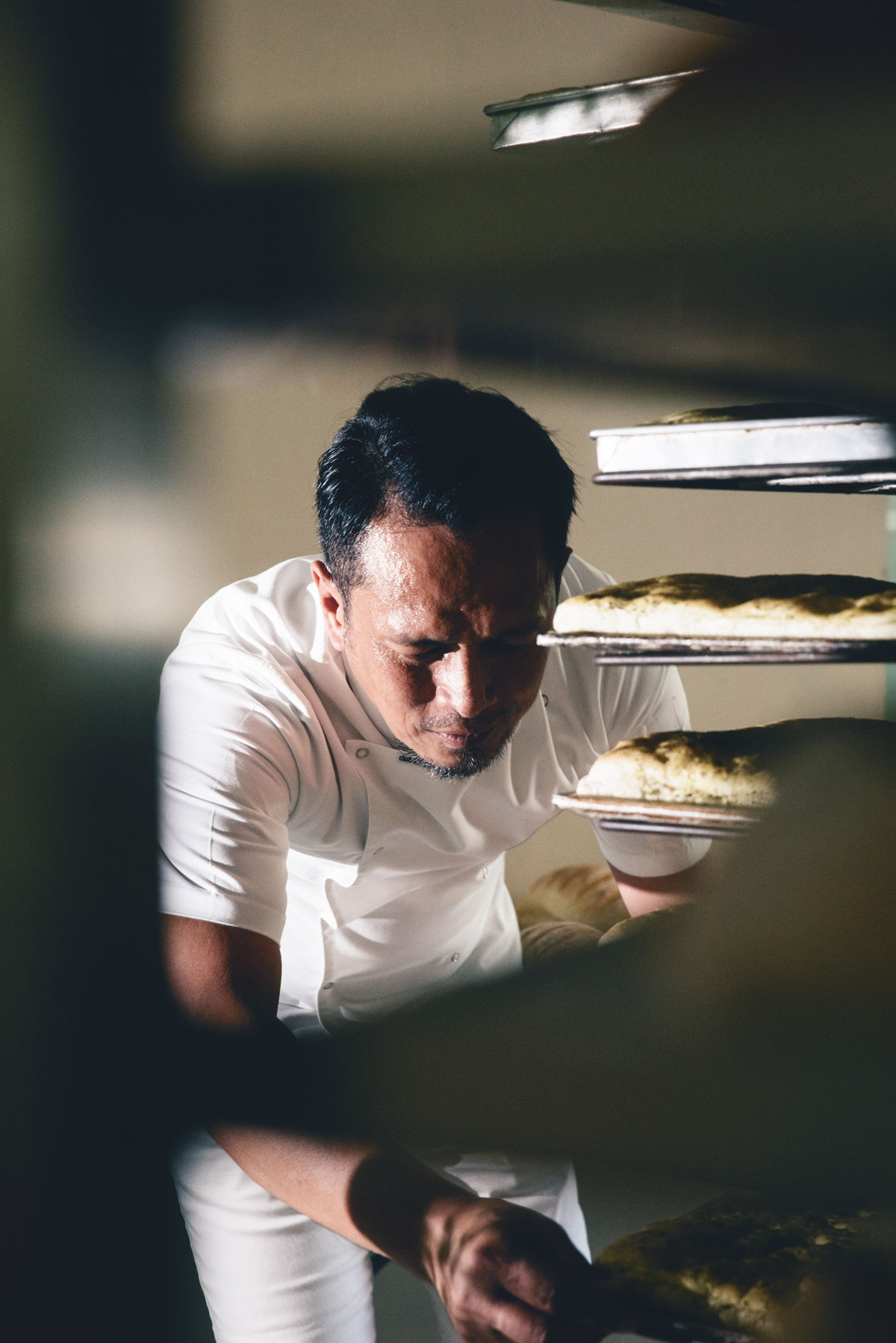 Chef Sau del Rosario inspecting the quality of his bread