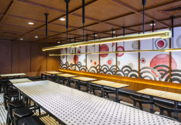 Bespoke light fixtures frame the hand-painted mural in the Tatami Room