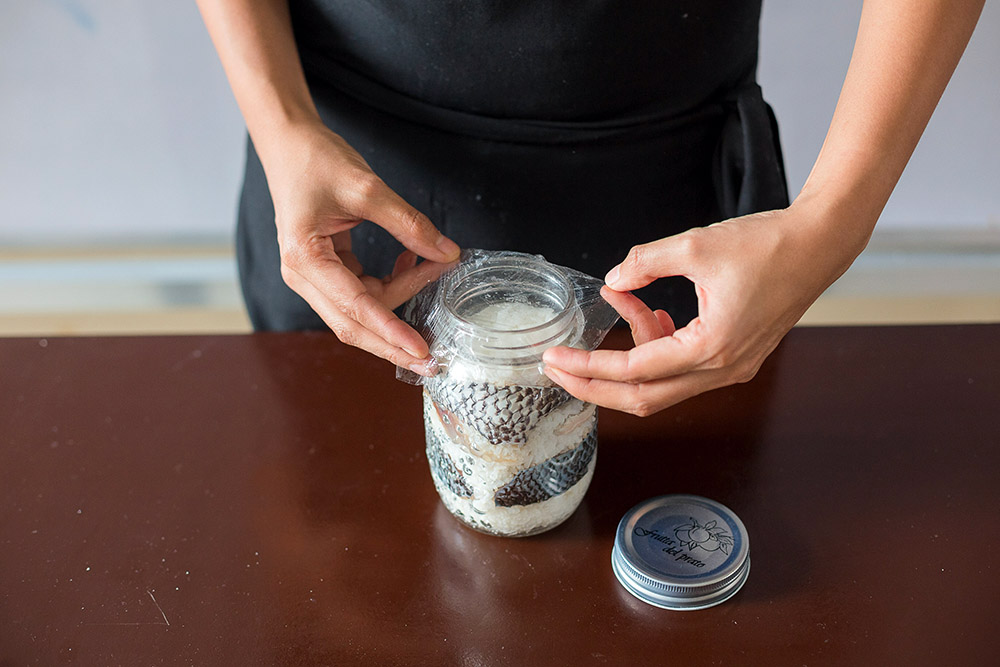 Cover mouth of the jar with cling wrap, then tightly screw on the lid. Place in a cool, dark place for 5 to 8 days. Every 2 to 3 days, you can check each jar and push the mixture down so it is covered by the expelled liquid