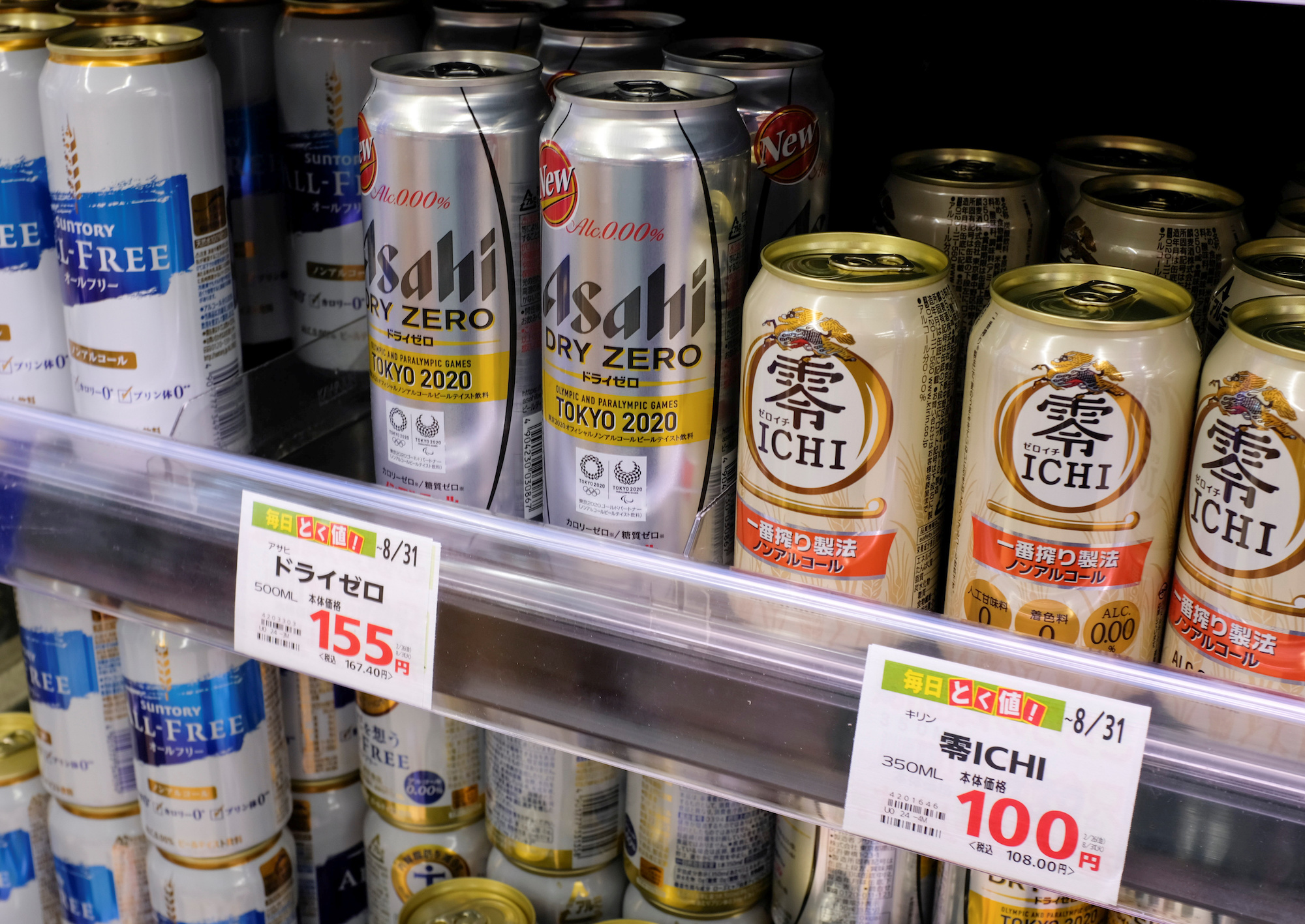 Various cans of alcohol-free beers are displayed on a supermarket shelf in Tokyo
