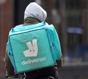 A Deliveroo delivery rider cycles in London, Britain