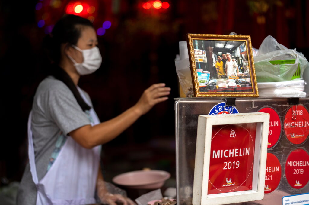 Jirintat Tangsupmanee, 45, works next to a picture of her late father Chanchai Tangsupmanee at their Bangkok stall
