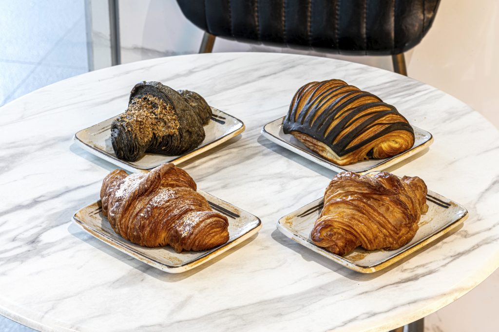 The Coffee Academics croissant selections: classic, black coconut (made with activated charcoal and filled with a coconut custard), chocolate, and custard