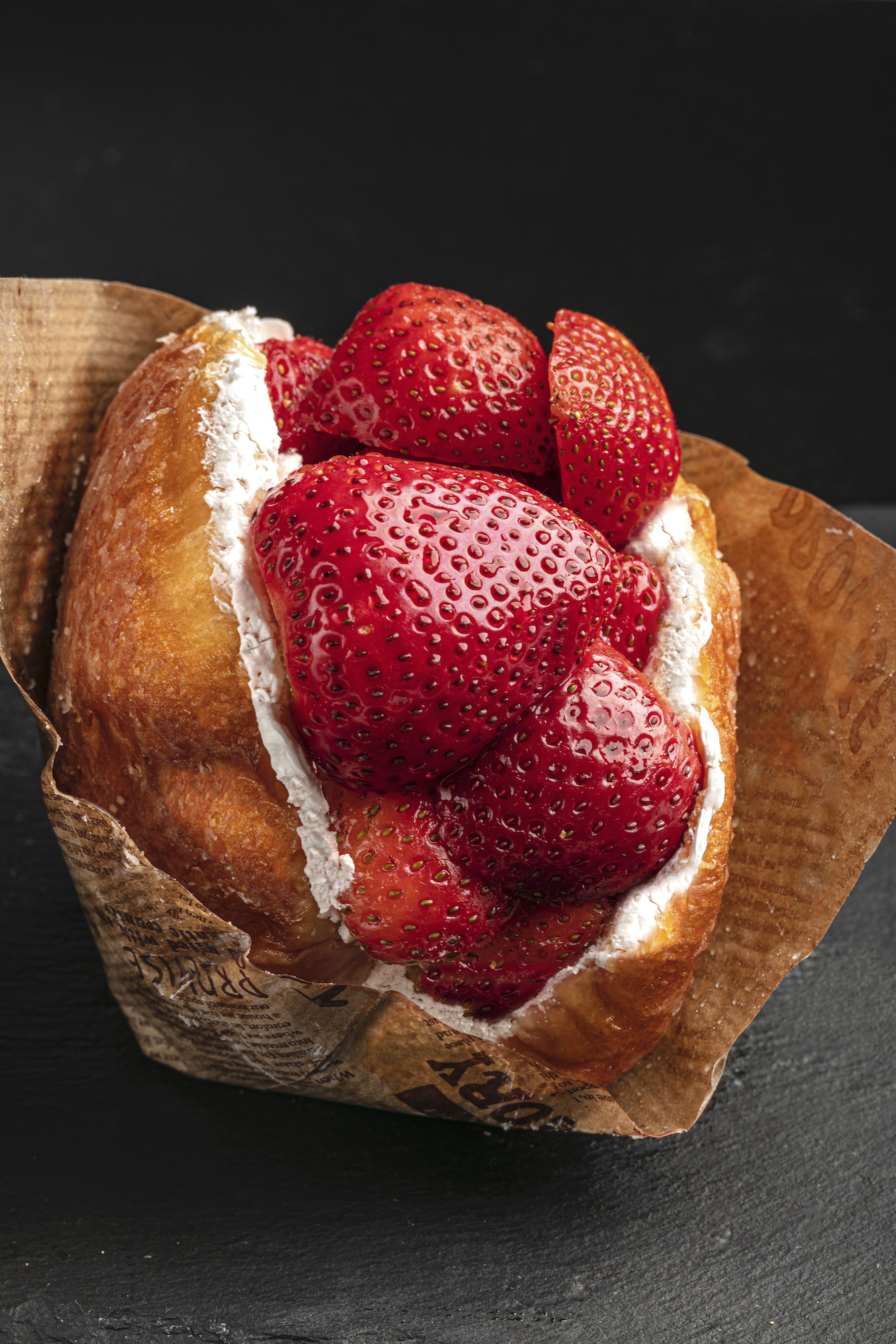 We Knead Bread's Strawberry Cream Donut, a glazed doughnut with whipped cream and fresh strawberries