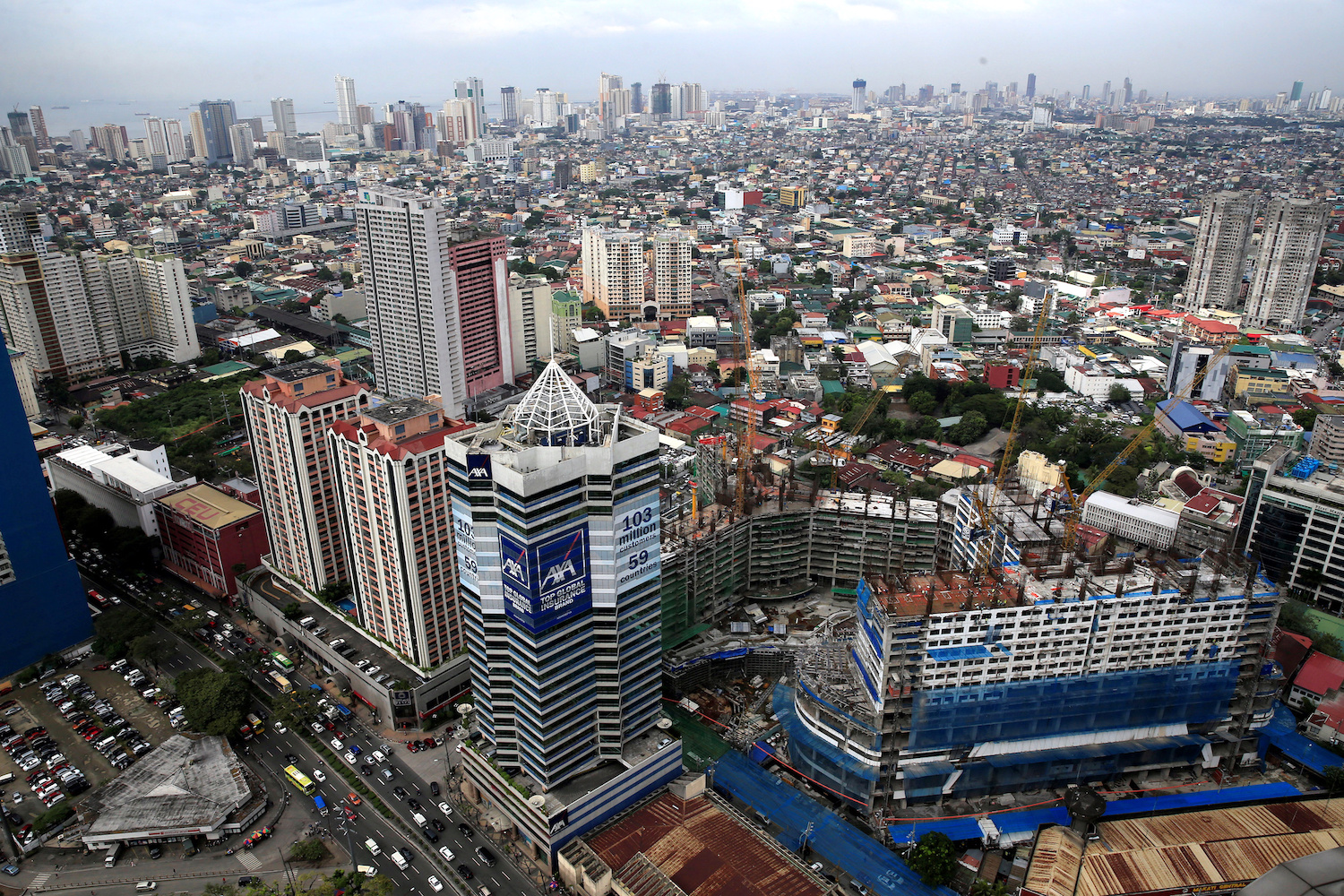 Philippine economic growth: Construction of new buildings alongside older establishments is seen within the business district in Makati City, Metro Manila, Philippines
