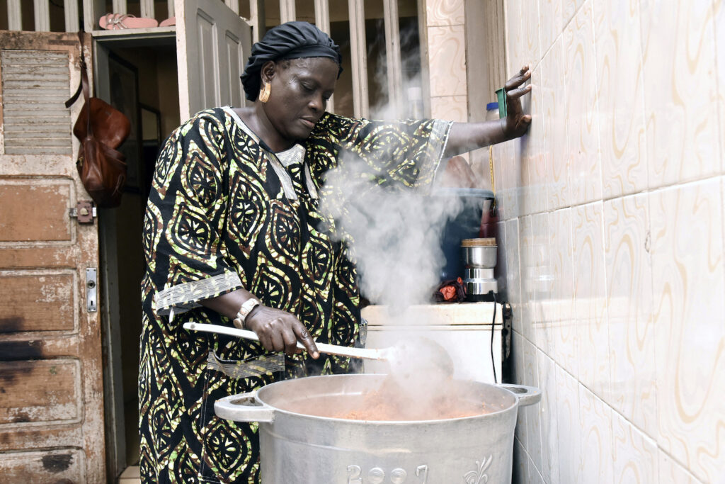 Senegalese cook Thiane Ngom prepares a traditional "thiebou dieune" at her home in Dakar, Senegal