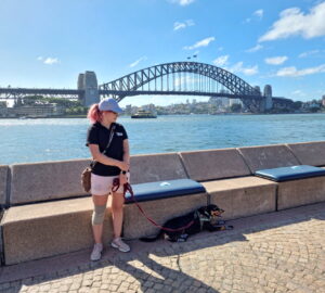 Australian kelpie dog Rasy and Mad Dogs and Englishmen dog handler Carla Shoobert take a break after patroling for seagulls at Sydney’s Opera Bar