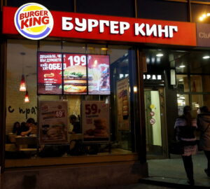 FILE PHOTO: Women walk outside a Burger King restaurant in Moscow, Russia