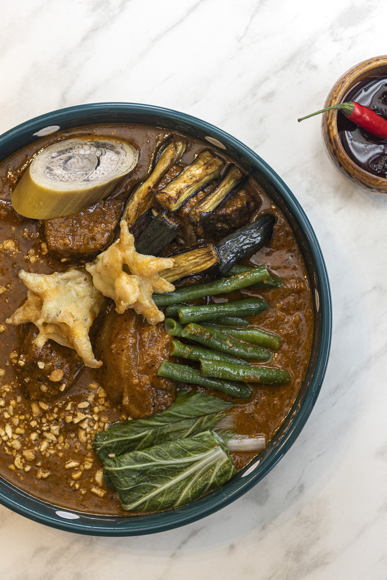 Esmeralda kare-kare: Beef and oxtail peanut stew with eggplant, string beans, and pechay served with their signature bagoong