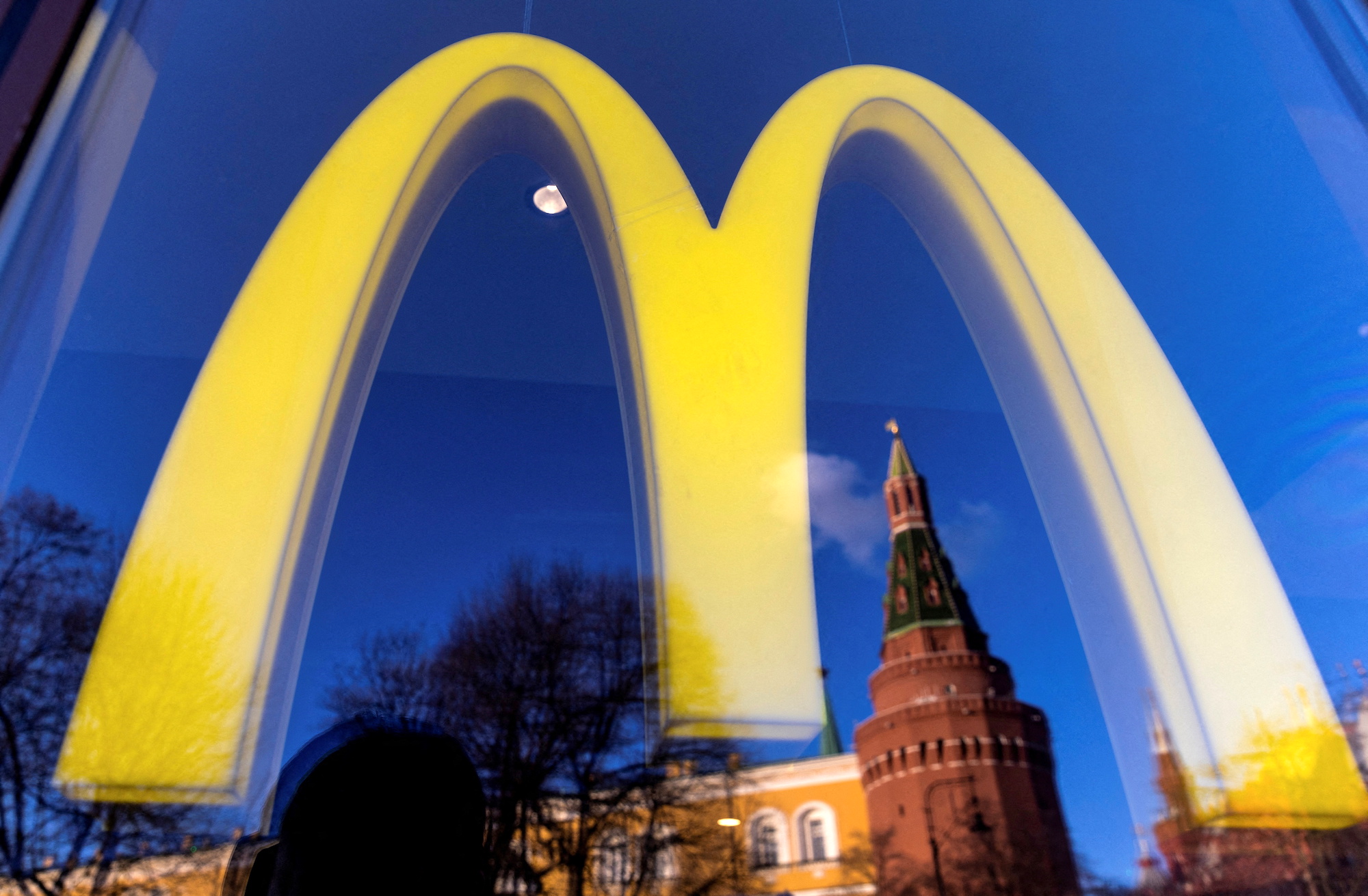 FILE PHOTO: A logo of the McDonald's restaurant is seen in the window with a reflection of Kremlin's tower in central Moscow, Russia