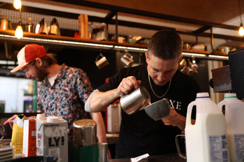 Barista Claudio Chimisso prepares a coffee at Bay Ten Espresso, a cafe that has struggled with filling staff job openings in recent months due to a worker shortage according to its owner, in Sydney, Australia