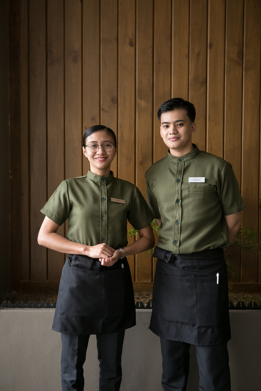 The chic uniforms and the spirit of omotenashi harmonize with the overall design and appeal of Yūgen Japanese Restaurant