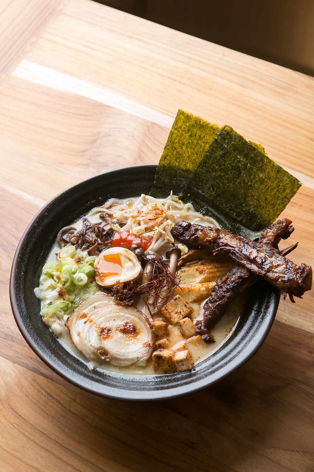 Yokozuna Ramen: Blanched egg noodles topped with menma, chasu, shredded kikurage, braised baby corn, shimeji, fried tofu, nori and braised pork ribs in a creamy tonkotsu soup