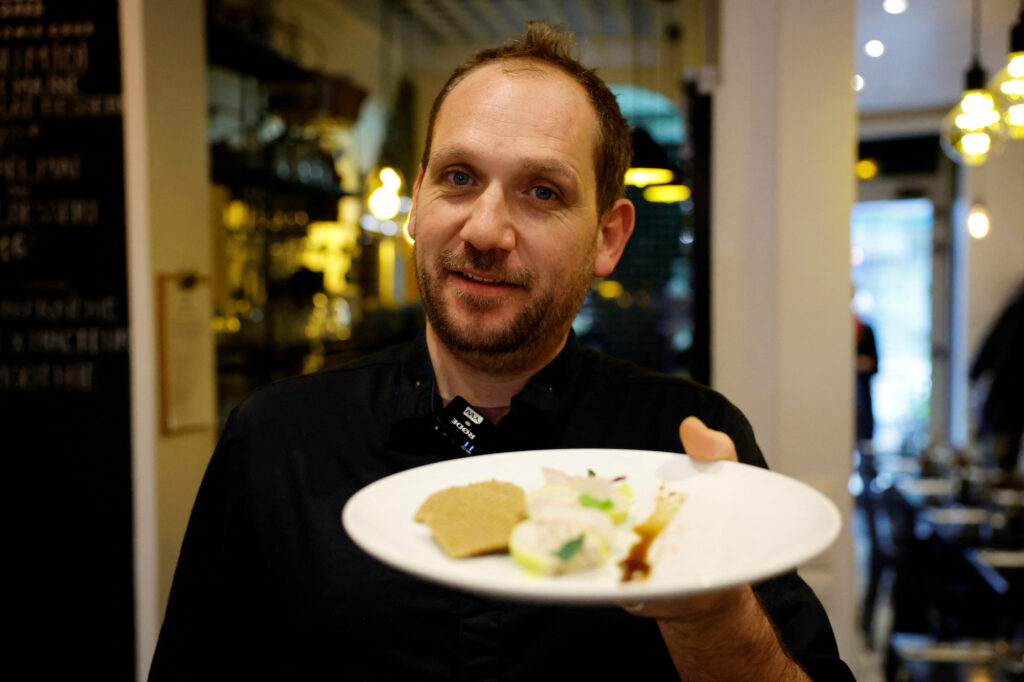 French chef Fabien Borgel displays a dish of 'faux-gras', a vegan alternative to foie gras, as he poses in his restaurant 42 Degrés in Paris, France