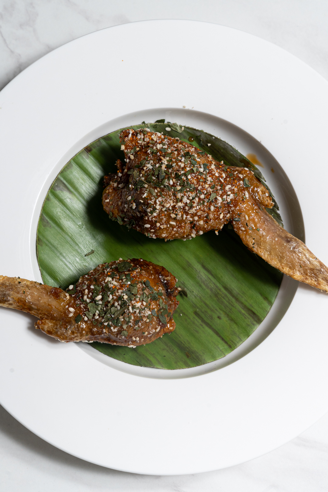 Wings: Fried mid wings, marmite-butter sauce, curry, sesame seeds