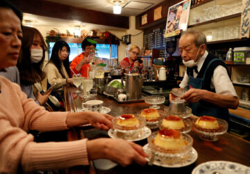 Shizuo Mori serves a pudding to customers at his Heckeln coffee shop in Tokyo, Japan
