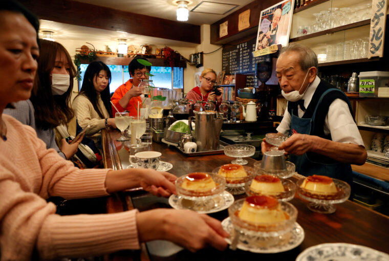 Shizuo Mori serves a pudding to customers at his Heckeln coffee shop in Tokyo, Japan