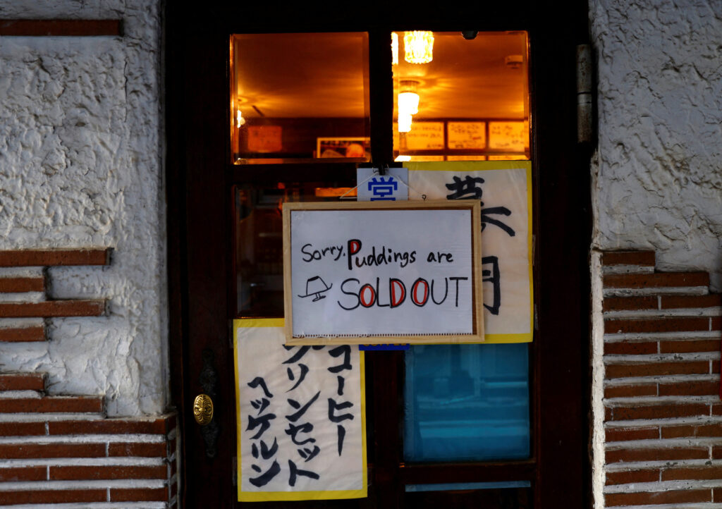 A sign announcing puddings are sold out is hung at Shizuo Mori’s Heckeln coffee shop