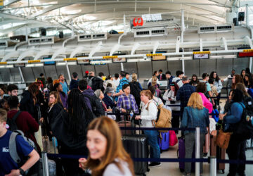 Travelers wait to check in at John F. Kennedy International Airport in New York City, U.S.