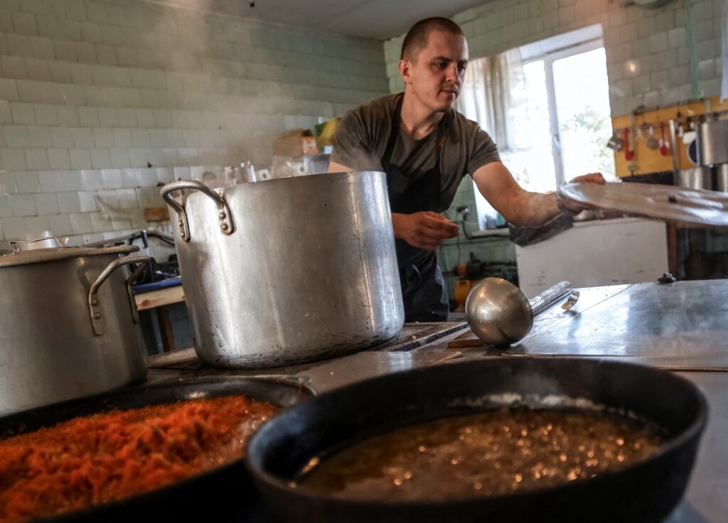 Serhiy, 30, a former restaurant chef and military cook prepares a meal, amid Russia's attack on Ukraine, in Dnipropetrovsk region, Ukraine