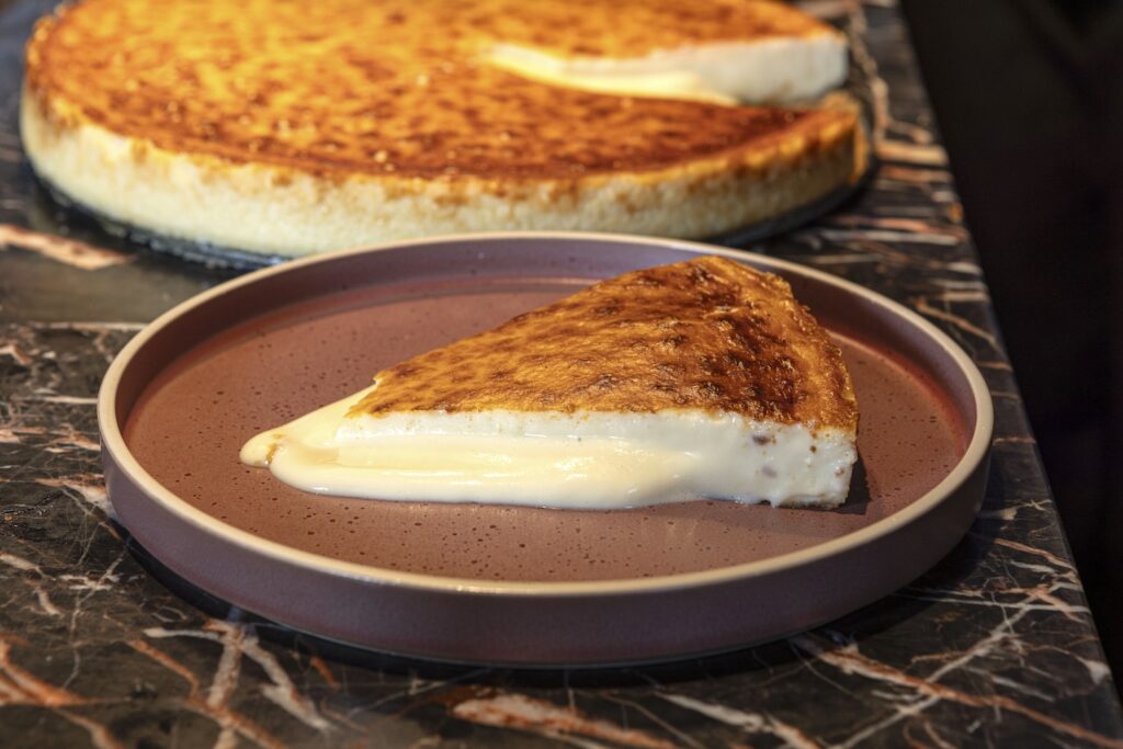 The signature of Fernando Alcalá’s award-winning cheesecake is how it oozes onto the plate with its creaminess