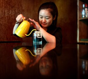 FILE PHOTO: A barista makes drip coffee at the La Tercera cafe in Beijing, China May 6, 2017. REUTERS/Thomas Peter/File Photo