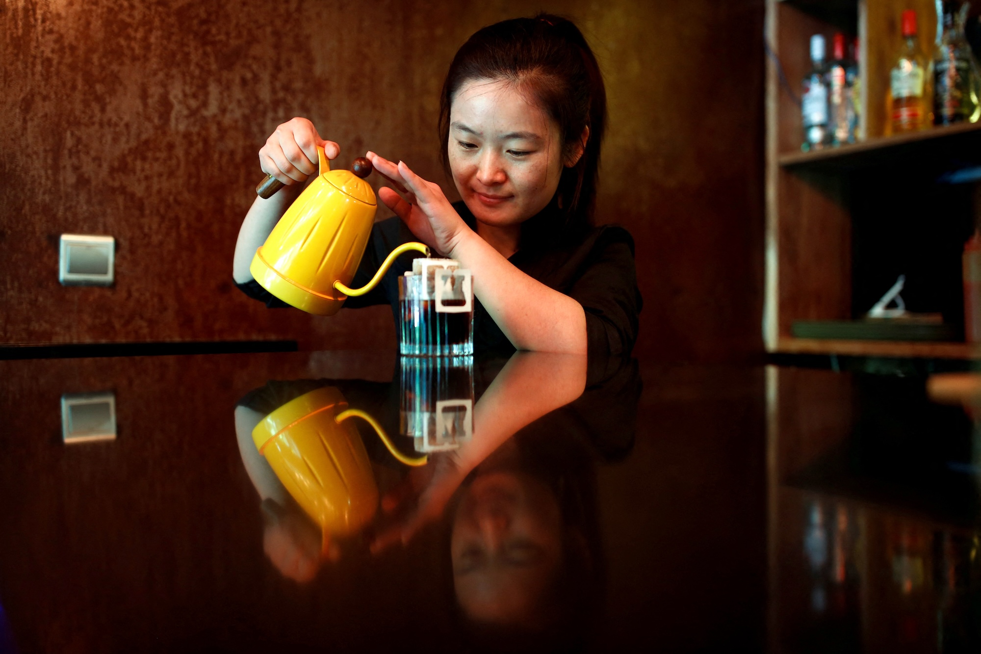 FILE PHOTO: A barista makes drip coffee at the La Tercera cafe in Beijing, China May 6, 2017. REUTERS/Thomas Peter/File Photo