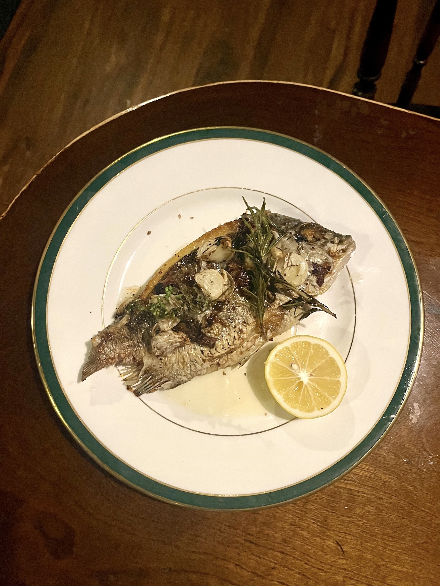 Sea bream fried in chicken fat, garlic, and rosemary